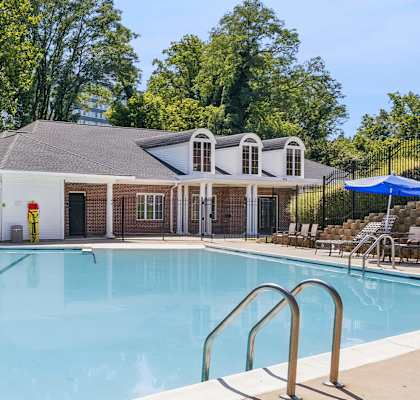 A large swimming pool with a building in the background.