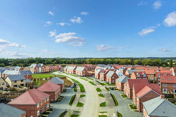 A residential area with houses and a clear sky.