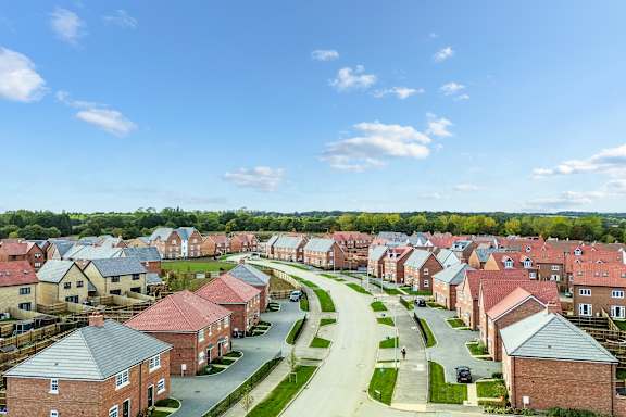 A residential area with houses and a clear sky.