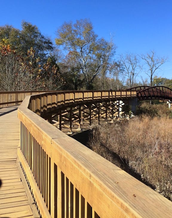 wooden bridge over a river at District on the Etowah Apartments, Canton, GA