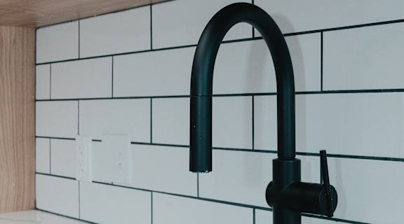 a close up of a kitchen sink and a black faucet at Howard Manor, Washington, DC
