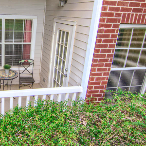 Enclave at Wolfchase Apartments in Cordova Tennessee photo of a small porch with a small table and two chairs