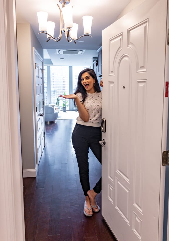 a woman standing in a doorway in a home at The Washington at Chatham, Pittsburgh, PA 15219