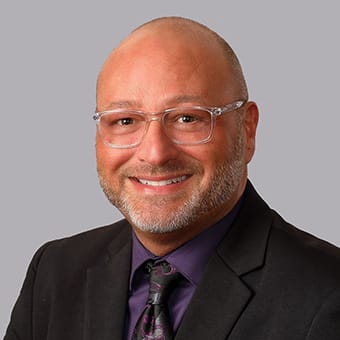 a man wearing glasses and a suit and tie