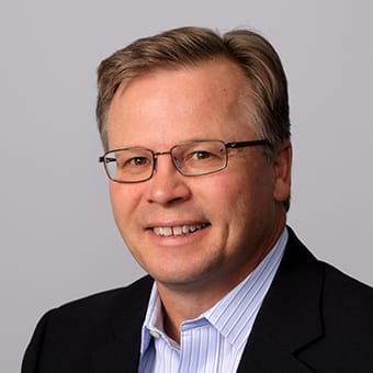 a man wearing glasses and a suit and tie