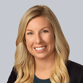 a smiling woman with long blonde hair and a black shirt