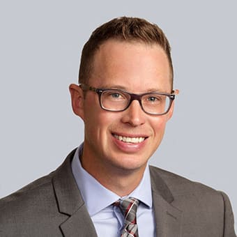 a man wearing glasses and a suit and tie