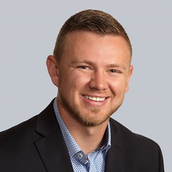 a man in a suit and tie smiling