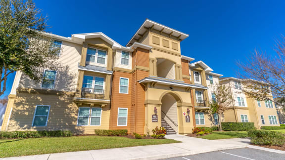 an apartment building with a sidewalk in front of it