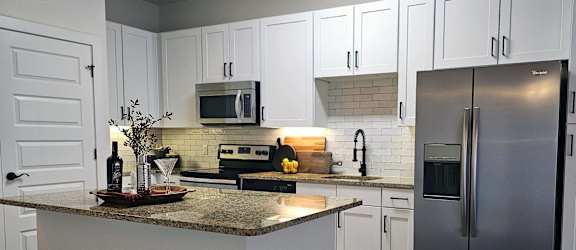 a kitchen with stainless steel appliances and a counter top at Waterford RiNo Apartments, Colorado