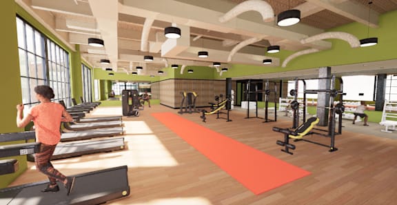 A woman is working out on a treadmill in a gym. at University Commons in Pittsburgh, PA