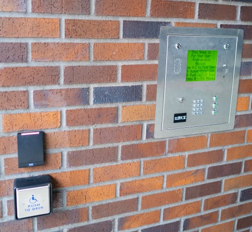 a brick wall with a light switch and buttons on it