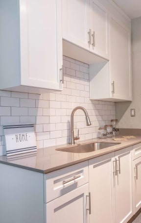 a kitchen with cabinets and stainless steel appliances at Avondale Station Apartments in Decatur, GA