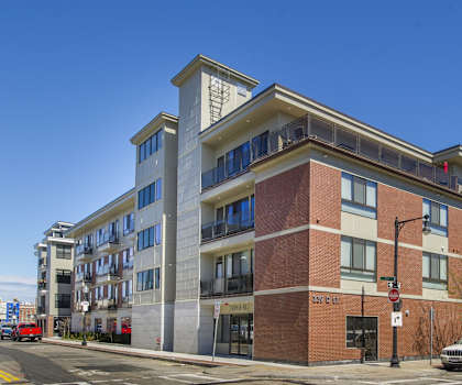 an apartment building on the corner of a city street
