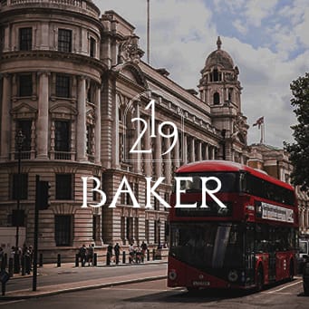 a red double decker bus driving down a city street
