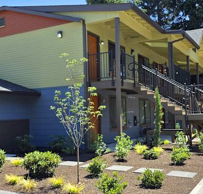 A modern house with a red, green, and yellow exterior.