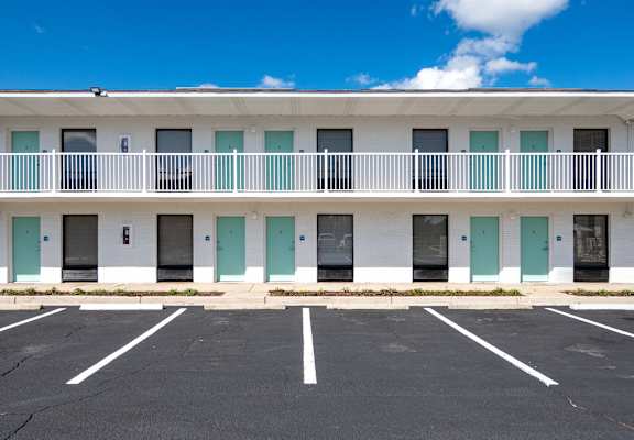 an empty parking lot in front of a building with balconies at The Teale Navy Yard, North Charleston, SC