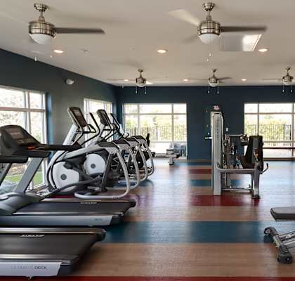 a gym with treadmills and other exercise equipment at The Crest at Naples, Naples, Florida