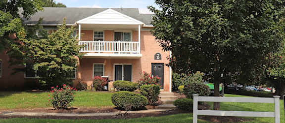 a house with a white fence in front of it