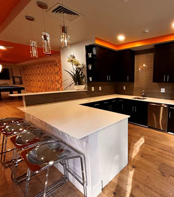 A modern kitchen with a white island and stainless steel appliances.