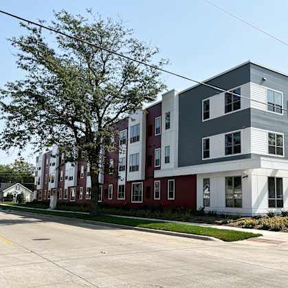 a new apartment building on the corner of a street