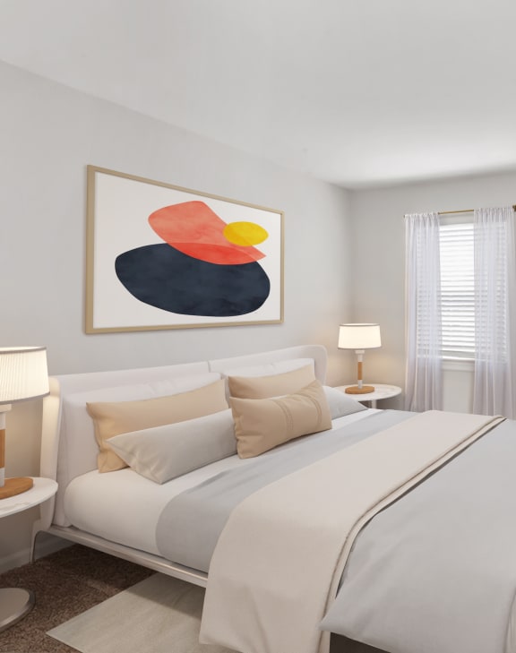 a bedroom with a large bed and two paintings on the wall at Staples Mill Townhomes, Richmond, VA