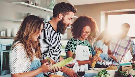 a group of people in a kitchen preparing food