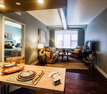 a living room and dining room with a table and a couch