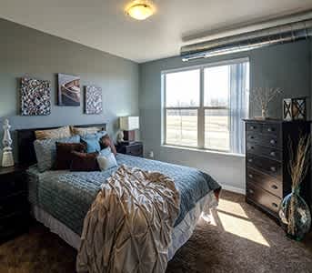 a bedroom with a bed and a window