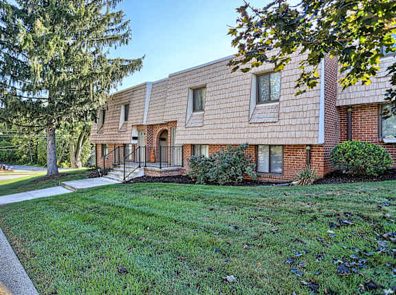 A house with a red brick exterior and a white roof.