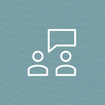 a white icon of people with a speech bubble above them