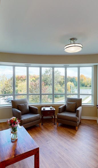 a living room with two chairs and a table