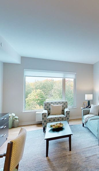 a living room filled with furniture and a large window