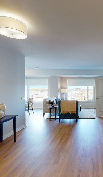 a living room filled with furniture and a large window