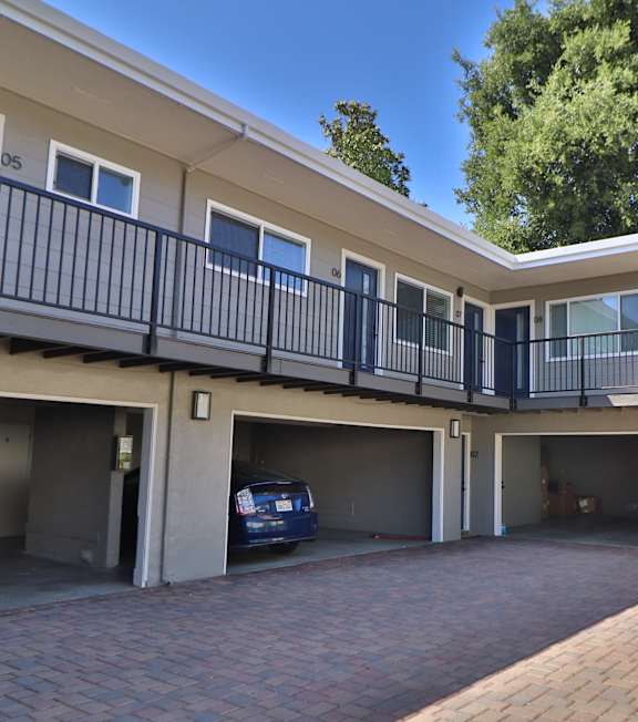 A small pool in a courtyard surrounded by apartment buildings.