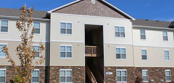 a large apartment building with a staircase in front of it at Residences at Northgate Crossing, Columbus, Ohio
