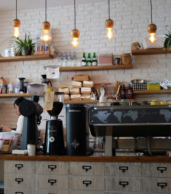 a coffee shop with a counter and a espresso machine