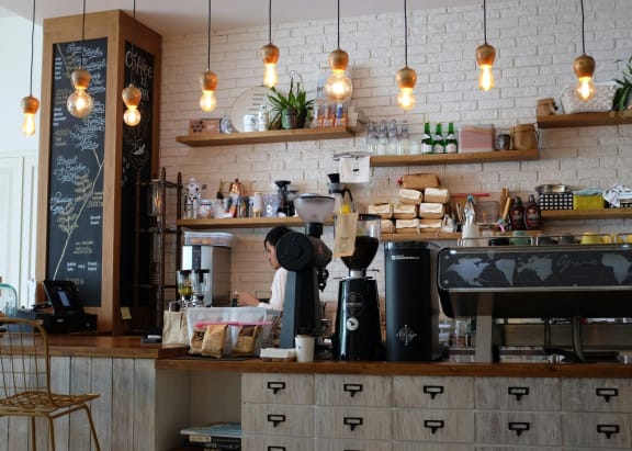 a coffee shop with a counter and a espresso machine at Hillsdale Garden Apartments, San Mateo, California