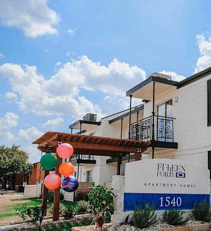 the front of a building with balloons in front of it