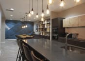 Thumbnail 5 of 19 - a kitchen with a large island and chairs in front of a table and a sink