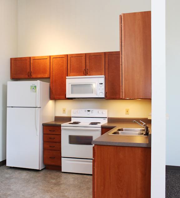 a living room and kitchen with a couch and a table