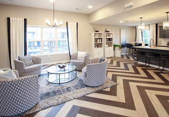 a living room with chairs and a table