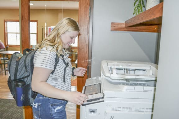 a woman using a laptop computer on a printer at Boulder Ridge, Minnesota
