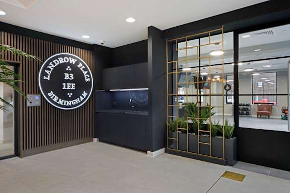 the lobby of a restaurant with a large clock on the wall