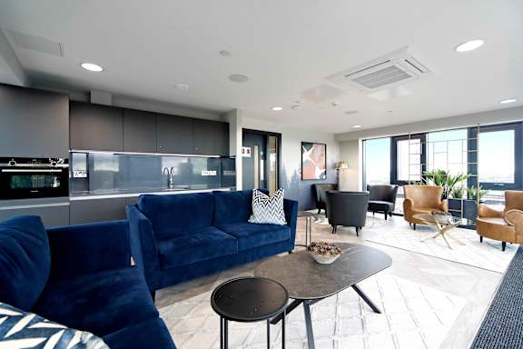 a living room with blue couches and a coffee table