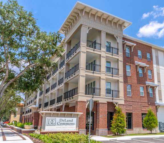 A multi-story apartment building named DeLand Commons is shown.