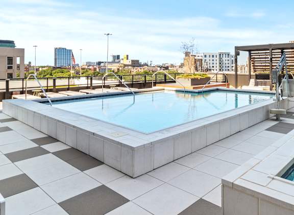 A rectangular pool with a black and white tiled floor.