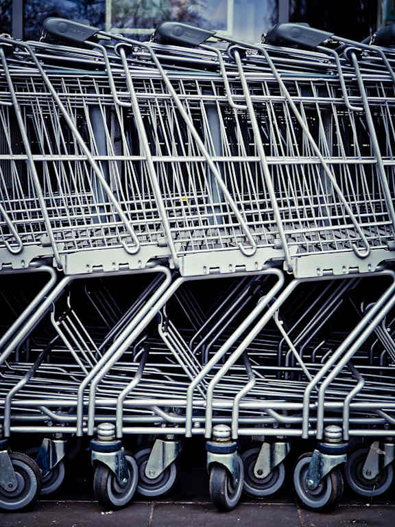 A group of shopping carts are lined up.