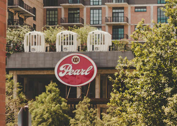 A building with a red sign that says "Pearl" on it.