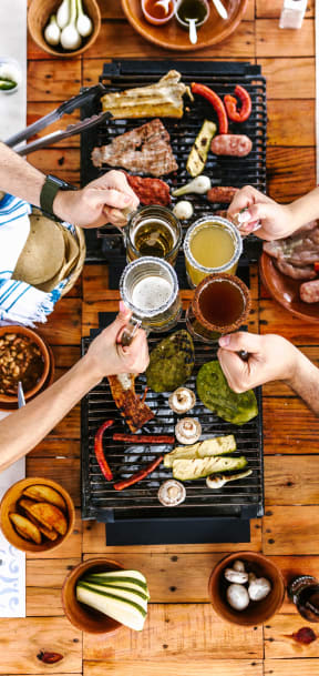 a group of peopleasting food on a barbecue grill
